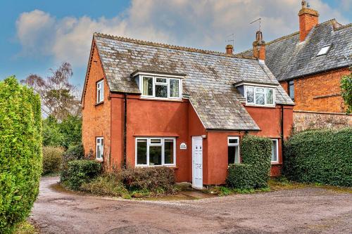 a red brick house with a white door at Finest Retreats - Glebe Cottage in Wellington