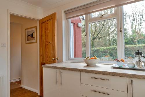 a kitchen with a window and a counter top at Finest Retreats - Glebe Cottage in Wellington