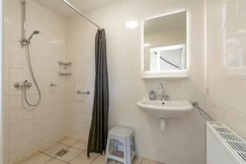 y baño con ducha y lavamanos. en Villa Duynopgangh 16 Julianadorp aan Zee en Julianadorp