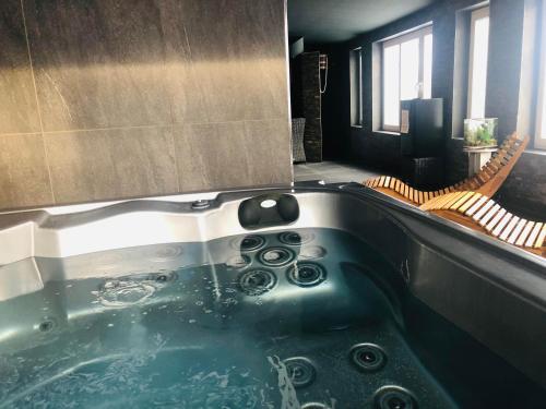 a bath tub in a bathroom with two chairs at Ubytovanie MI - TATRY in Kravany