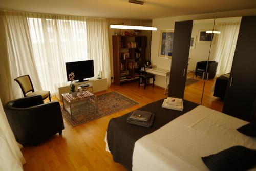 ホルゲンにあるEsther's Homestay - Big Room - 26 Square Metersのベッドルーム1室(ベッド1台付)、リビングルームが備わります。