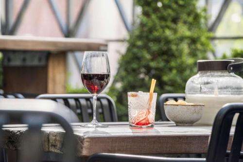 a glass of wine sitting on top of a table at Best Western ToRVEhallerne in Vejle