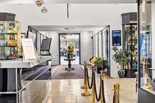 a store aisle with a counter with umbrellas at Best Western ToRVEhallerne in Vejle