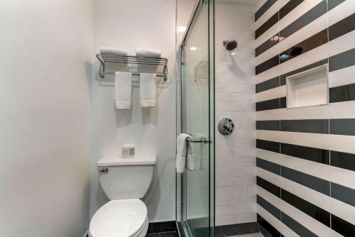 a bathroom with a toilet and a glass shower at Quality Inn & Suites Vacaville in Vacaville