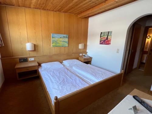 a bedroom with a bed and two night stands at Stammhaus im Hotel Alpine Palace in Saalbach Hinterglemm
