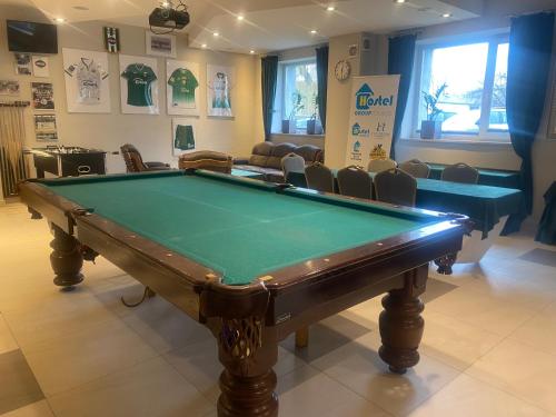 a billiard room with a pool table and chairs at Hostel Radom in Radom