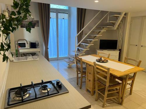 a kitchen and living room with a stove and a table at Centrale56 in Bisceglie