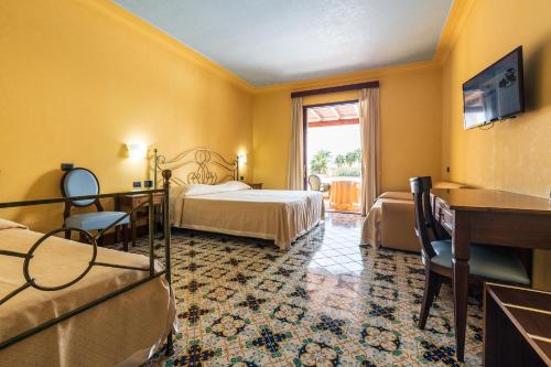 a hotel room with a bed and a window at Hotel Aktea in Lipari