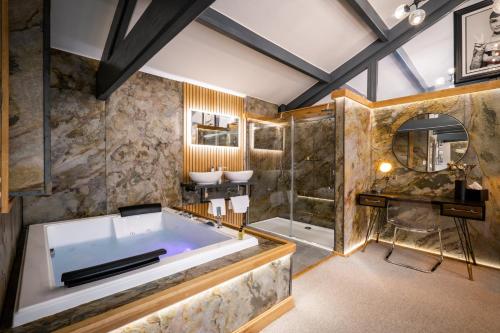 a large bathroom with a tub and a shower at Architect's Loft in Windermere
