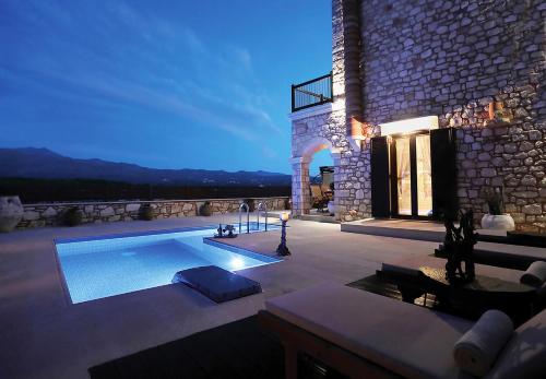 ein Haus mit einem Pool auf einer Terrasse in der Unterkunft Deluxe Villa LaCasa 2 with Private Pool in Roumelí