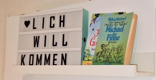 a couple of books on a wall at liebenswertes Apartment 10 Minuten zur Altstadt in Koblenz