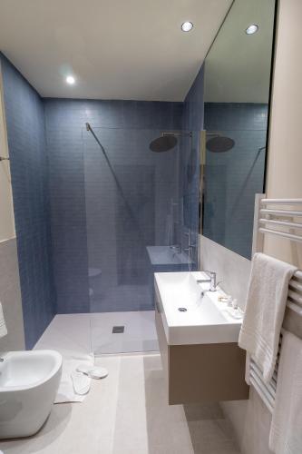 a bathroom with a toilet and a sink and a shower at Pasubio Quattro BB in Catania