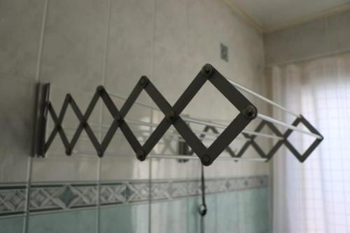 a metal rack on the wall of a bathroom at Studio middle of town centre. in Tornio