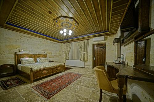 a bedroom with a bed and a chandelier at Zultanite Cappadocia Hotel in Nevsehir