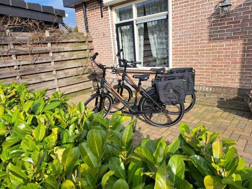 a bike parked in front of a brick building at Levenslust Hulshorst in Hulshorst