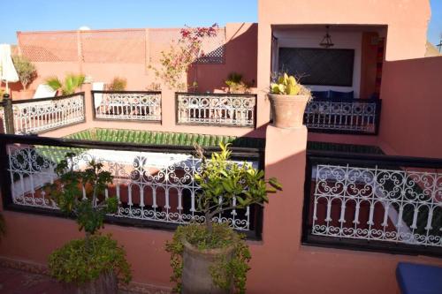 a balcony of a house with potted plants on it at Riad Musa in Marrakesh