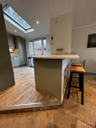 a large kitchen with a counter in a room at Lowena Lodge in Troutbeck