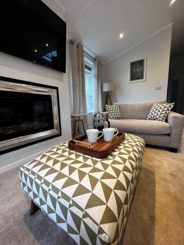 a living room with a table and a couch at Lowena Lodge in Troutbeck