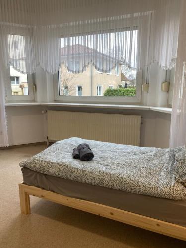 a bedroom with a bed with a hat on it at Monteurhaus Osnabrück Lüstringen in Osnabrück