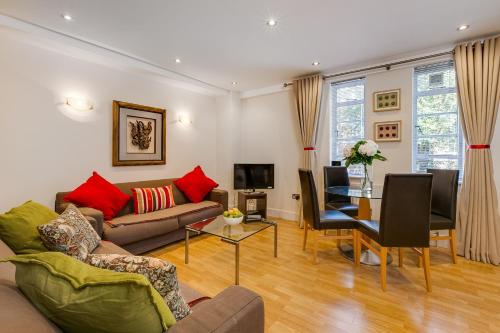 a living room with a couch and a table at Nell Gwynn Chelsea Accommodation in London