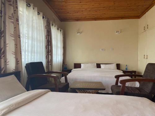 Postel nebo postele na pokoji v ubytování Ranges View Lodge Staycation