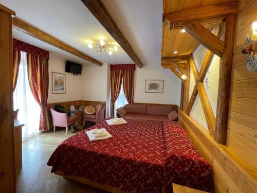 a bedroom with a red bed in a room at Hotel San Lorenzo in San Lorenzo in Banale