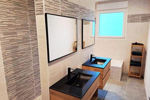 a bathroom with a sink and a mirror at La KAVAL Vosgienne in Frémifontaine