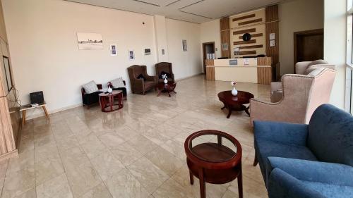 a living room with couches and chairs and a table at SPAR Furnished Hotel in Al Hofuf
