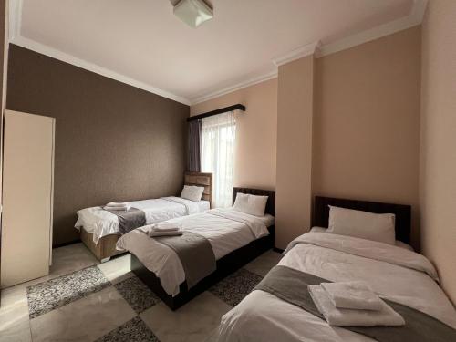 a bedroom with two beds and a window at RP HOTEL (NEW) in Yerevan
