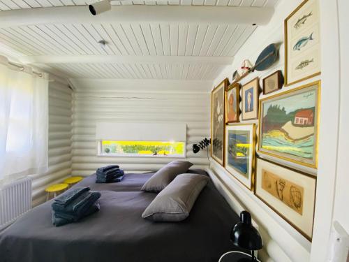 a bedroom with a bed with pillows and pictures on the wall at HAUS ZWEINEUN in Brodersby