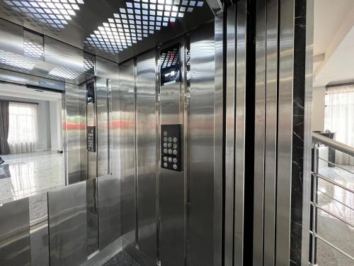 a elevator in a building with a glass wall at RP HOTEL (NEW) in Yerevan