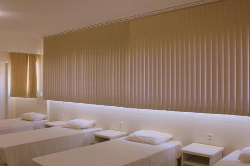 Cama o camas de una habitación en Hotel Itajaí Tur - Itajaí Navegantes