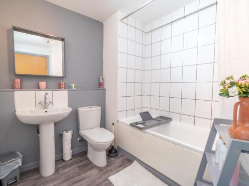 a bathroom with a sink and a toilet and a bath tub at Pass the Keys Nottingham City Centre One Bed Apartment in Nottingham