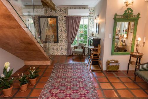 a living room with a staircase and a rug at Baruch Guesthouse on Lovell in Stellenbosch