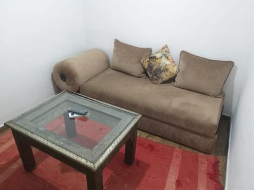 a living room with a couch and a table at Hôtel Agnaou in Marrakech