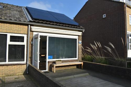 a window with a solar panel on the side of a house at ZeeBedStay in Noordwijk aan Zee