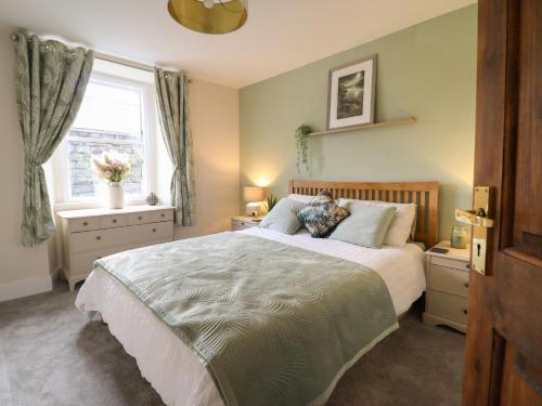 a bedroom with a large bed and a window at Bodlondeb in Porthmadog