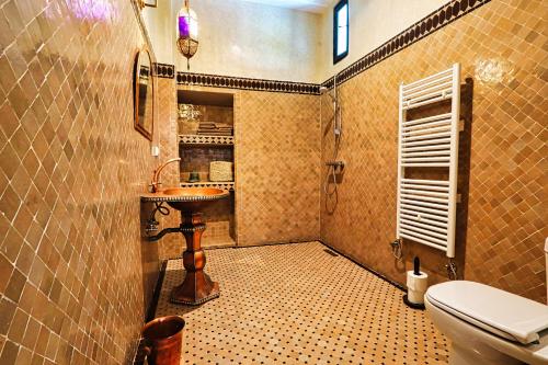 a bathroom with a toilet and a sink at Riad Al Wifak in Marrakesh