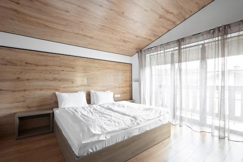 Ένα ή περισσότερα κρεβάτια σε δωμάτιο στο Mountain Residence 4*