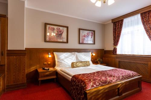 Postel nebo postele na pokoji v ubytování Hotel Abácie & Wellness