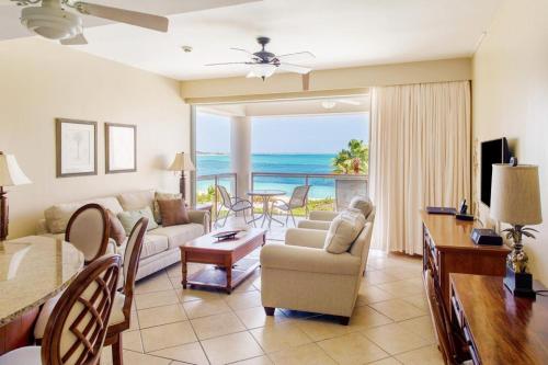 a living room with a view of the ocean at Coral Gardens on Grace Bay in Grace Bay