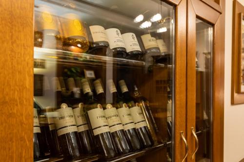 a display case filled with lots of wine bottles at Hotel Abácie & Wellness in Valašské Meziříčí