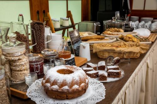 a table filled with different types of bread and pastries at Hotel Abácie & Wellness in Valašské Meziříčí
