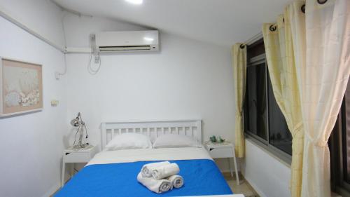 a bedroom with a bed with towels on it at Gilad's View in Bet Sheʼan