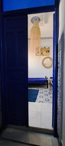 an open door to a bathroom with a tub at Riad chaoui house in Marrakech