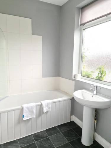 a white bathroom with a sink and a bath tub at Eastgate Road in Middlesbrough