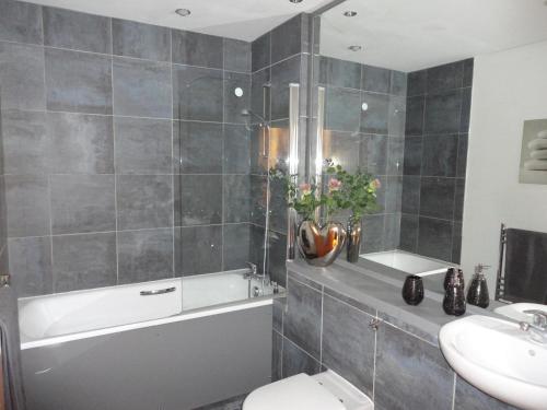 a bathroom with a tub and a toilet and a sink at Luxury Apartment Best location in Liverpool city center in Liverpool