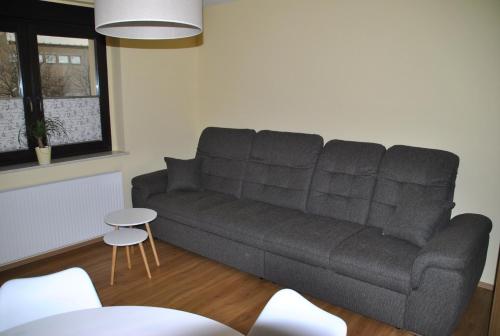 a living room with a couch and a table at Fewo / Monteurswohnung Heller Nerchau in Grimma