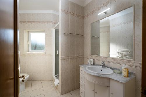 a bathroom with a sink and a mirror at Quinta de São Roque by Algarve Golden Properties in Lagos