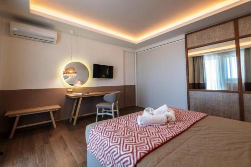 a hotel room with a bed and a desk at Asteris Village in Gerakini